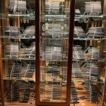 Knife collection displayed in a curio cabinet